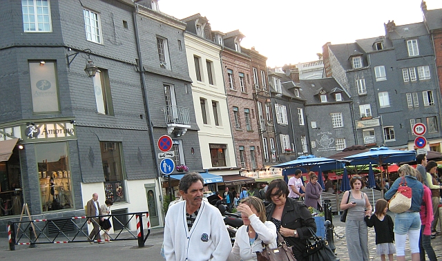 cafes and building with people all around in Honfleur